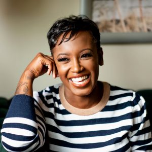 woman in striped sweater smiling at the camera