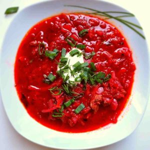 Ukrainian Borscht in a white bowl with toppings