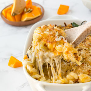 close up of a spoon scooping out mac n cheese from a dish