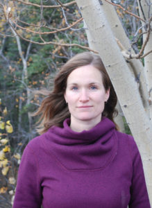 woman in a purple sweater outdoors