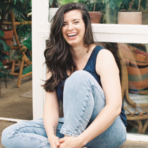 woman with brown hair sitting and smiling