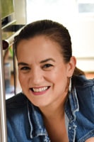woman with brown hair in a ponytail smiling
