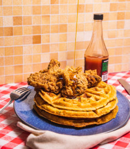 stack of waffles with fried chicken on a plate
