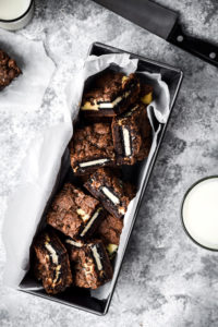 brownie squares with filling in a box with tissue paper