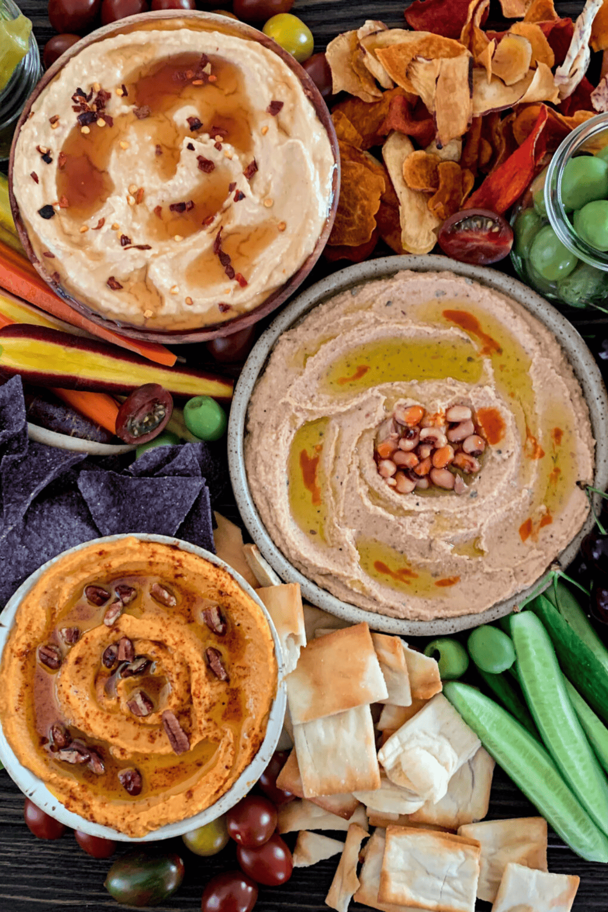 board with dips and veggies and chips