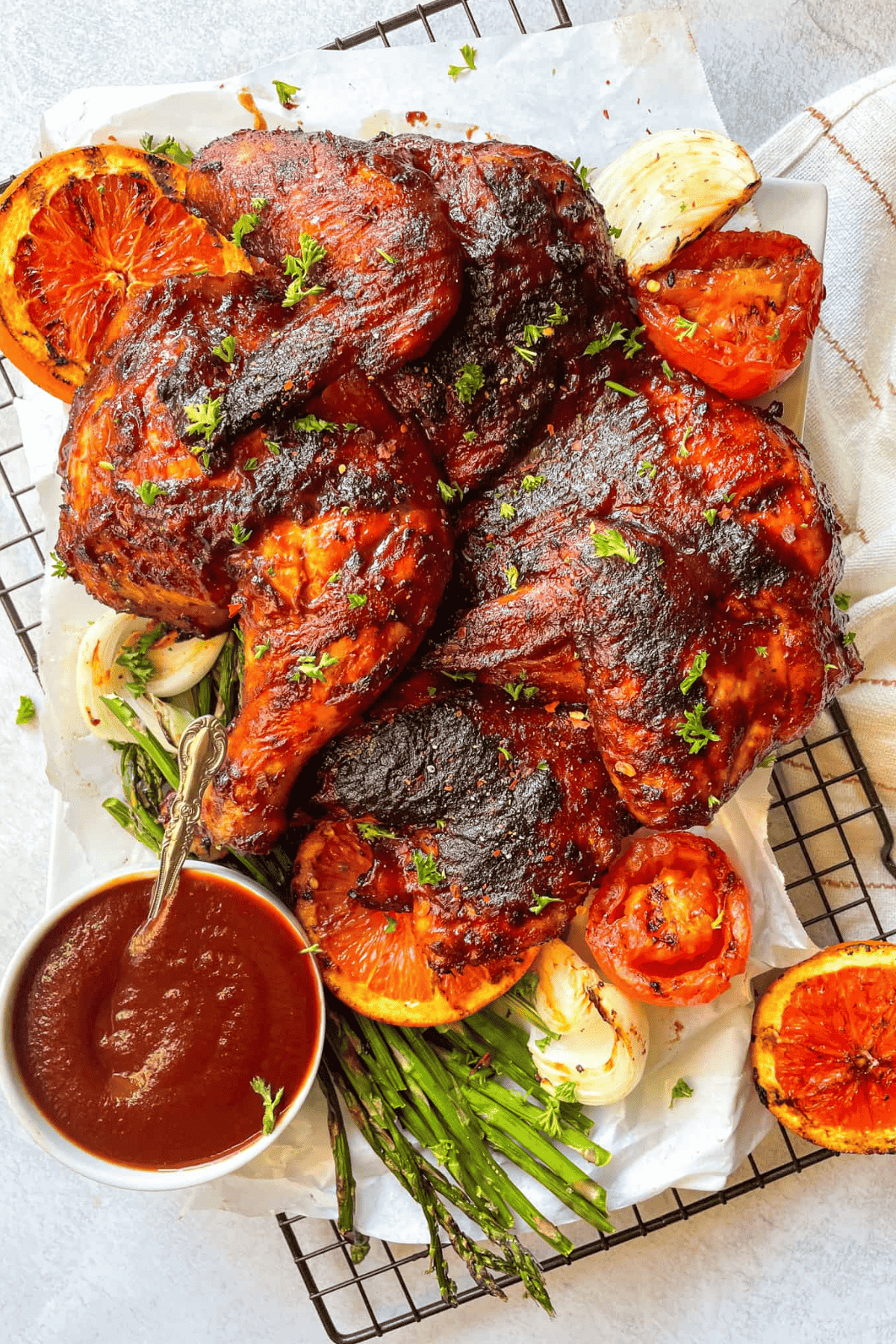 chicken coated in seasonings and on a cooling rack with sauce